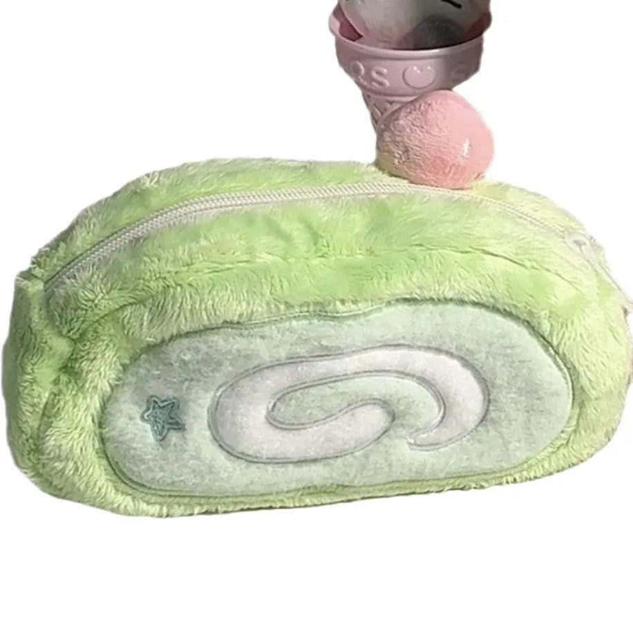 Honeydew roll plush velvet pencil case in Swiss roll cake colour on a desk.