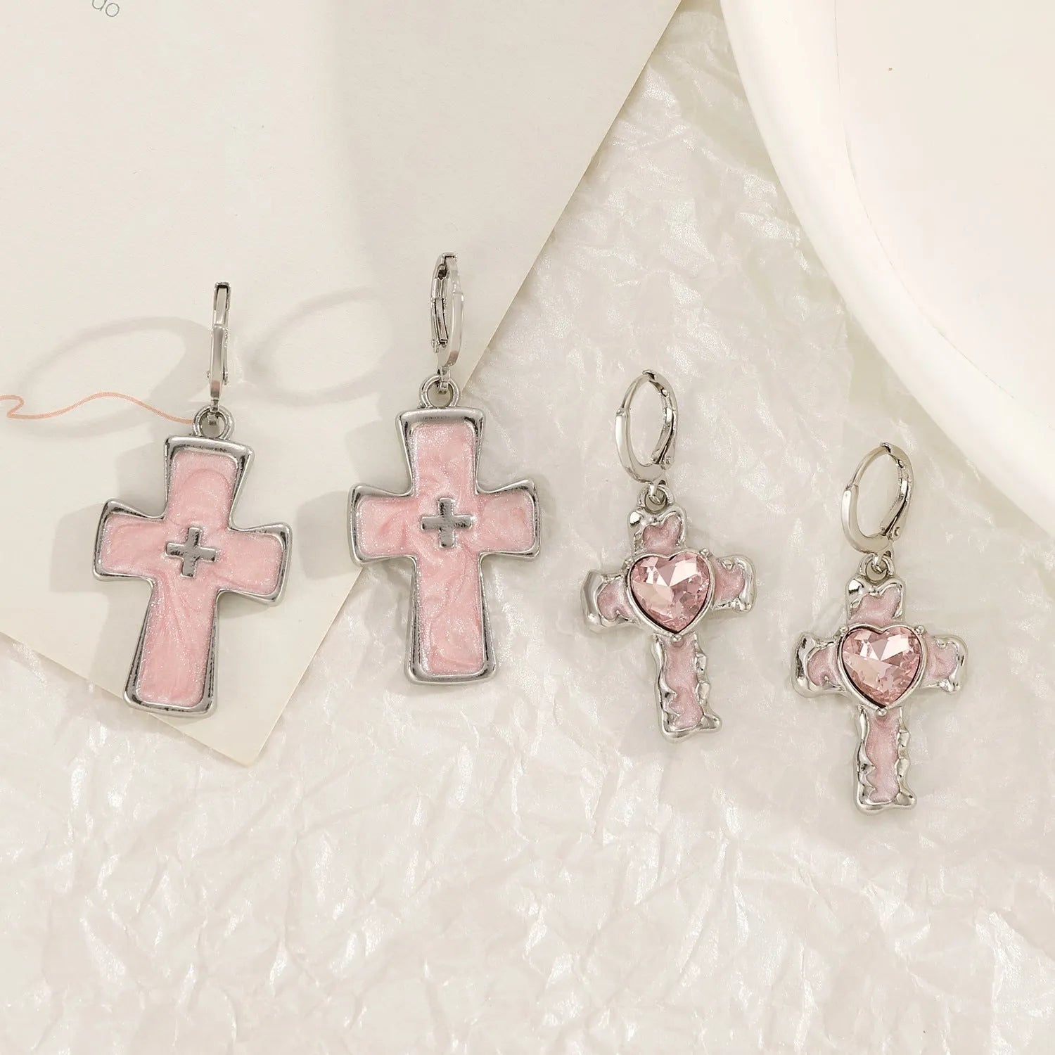 Women's alloy drop earrings showing cross, heart, and animal designs in five colour finishes