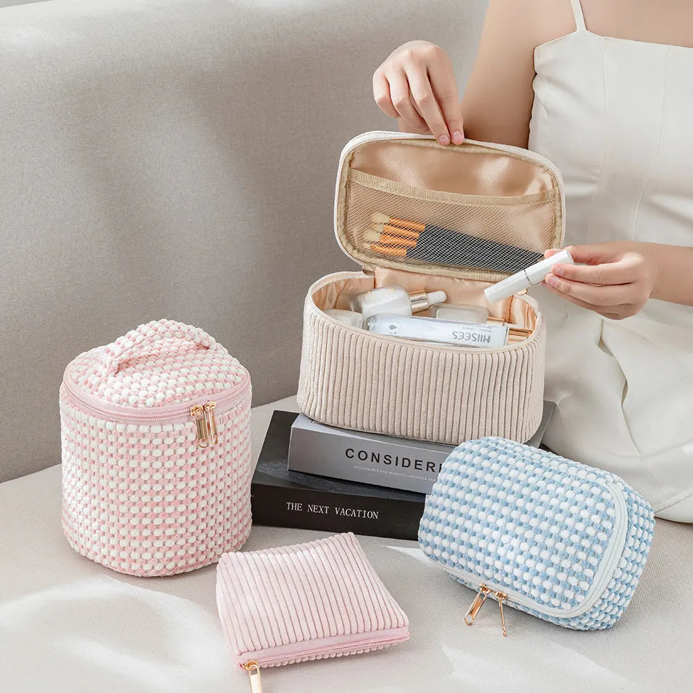 Set of four soft pink flannelette cube makeup bags with zips, arranged from largest to smallest.