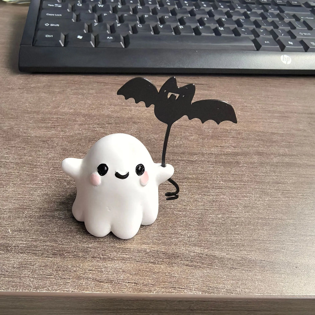 Mini resin Halloween statue of a cartoon ghost walking a bat, 4cm tall