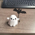 Mini resin Halloween statue of a cartoon ghost walking a bat, 4cm tall