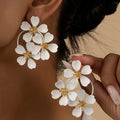 Retro flower-shaped fashion earrings for women in black and white colours with iron construction