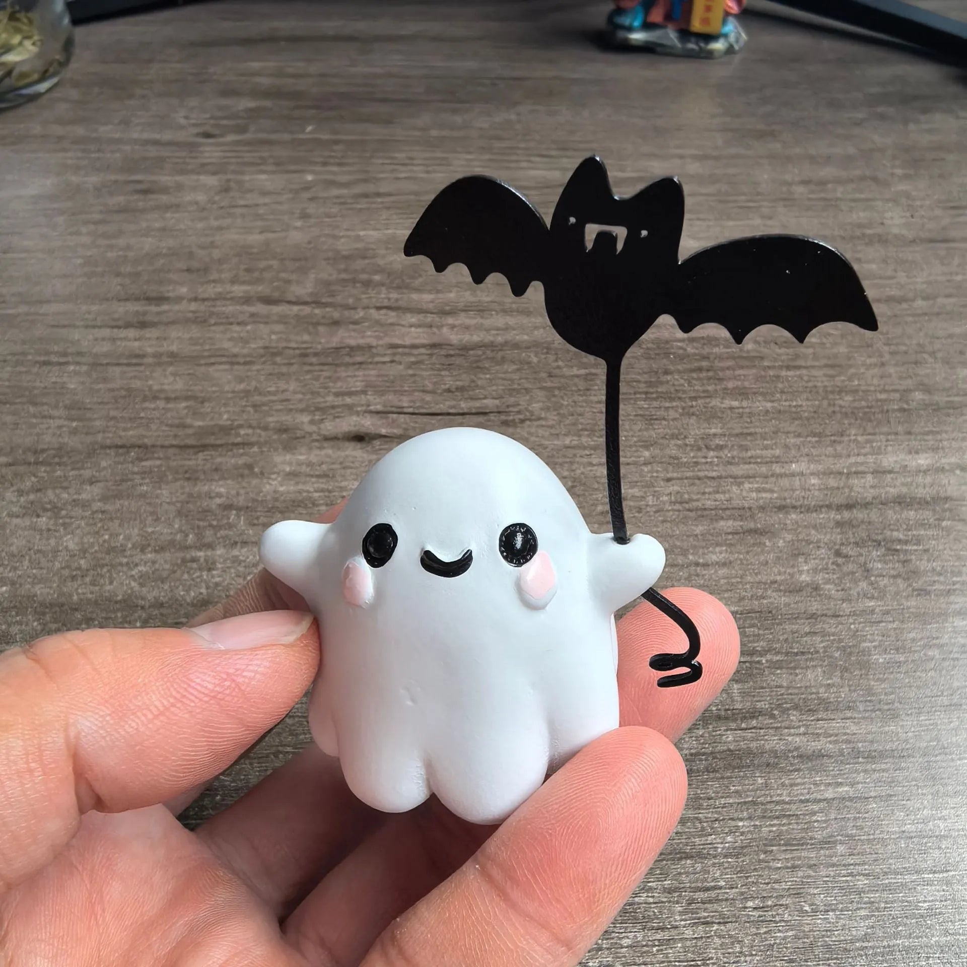 Mini resin Halloween statue of a cartoon ghost walking a bat, 4cm tall