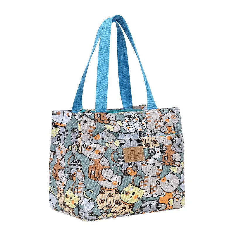 Women's large printed canvas tote bag with aluminium handles in a choice of floral and cat designs.