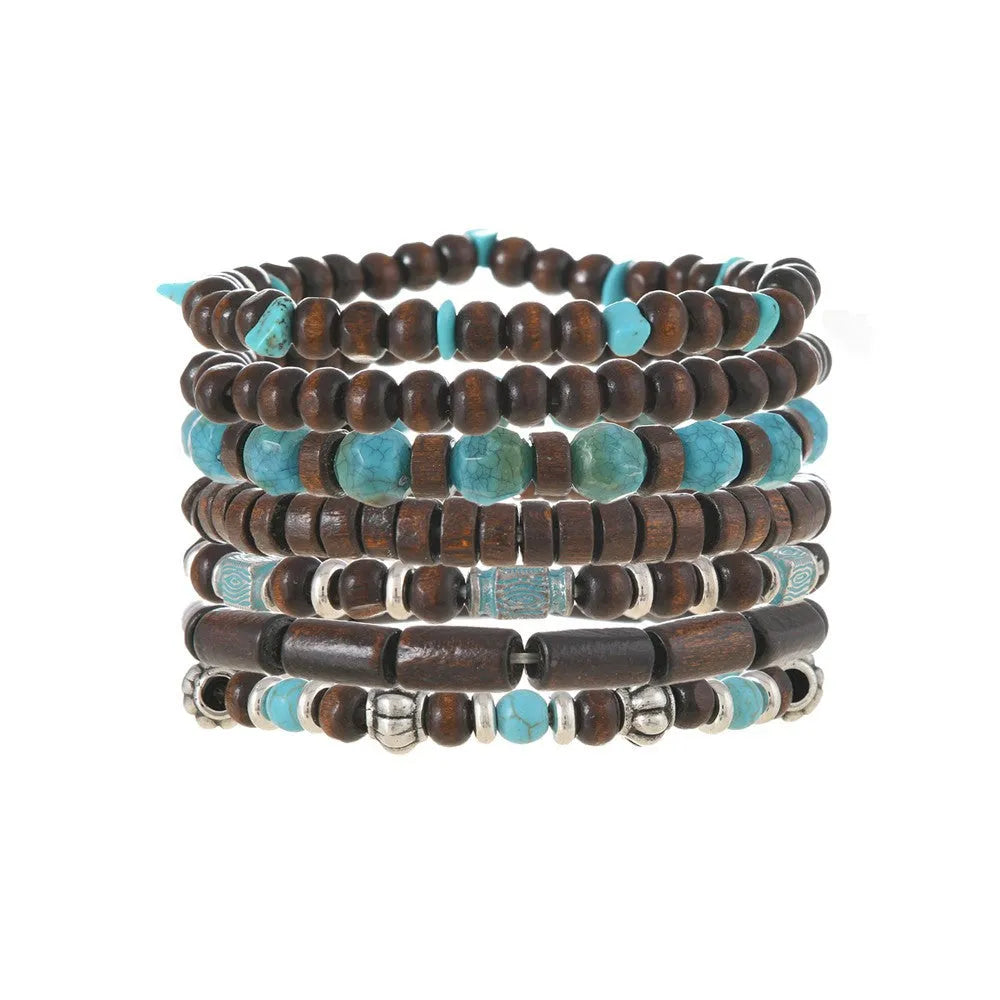 Set of seven multicolour retro bracelets with wooden beads and alloy charms laid flat.