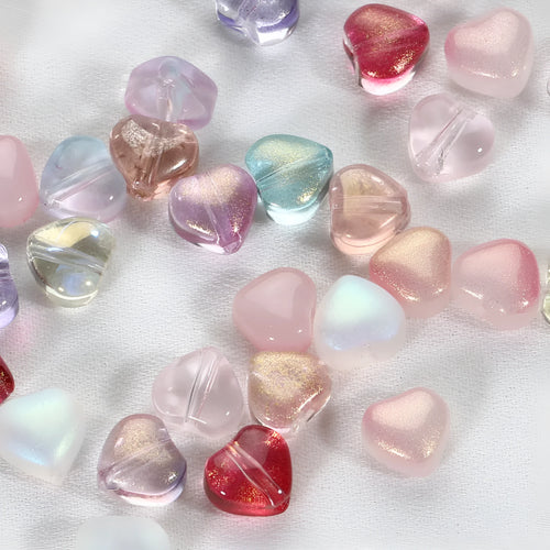 Twenty transparent Czech glass love heart spacer beads in assorted colours including aurora purple and peach gold.