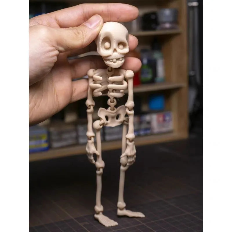 A tall 3D printed white skull refrigerator magnet for Halloween decoration.