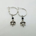 A pair of silver-coloured alloy round ring earrings with a Tibetan antelope design motif.