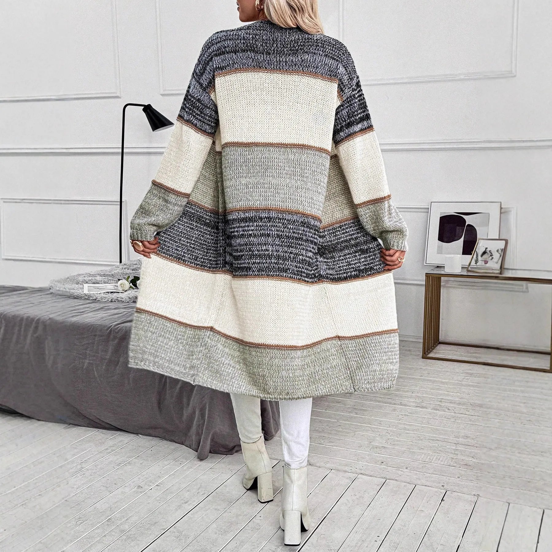 Grey stripe knitted long cardigan for women, loose fit with long sleeves on a hanger.
