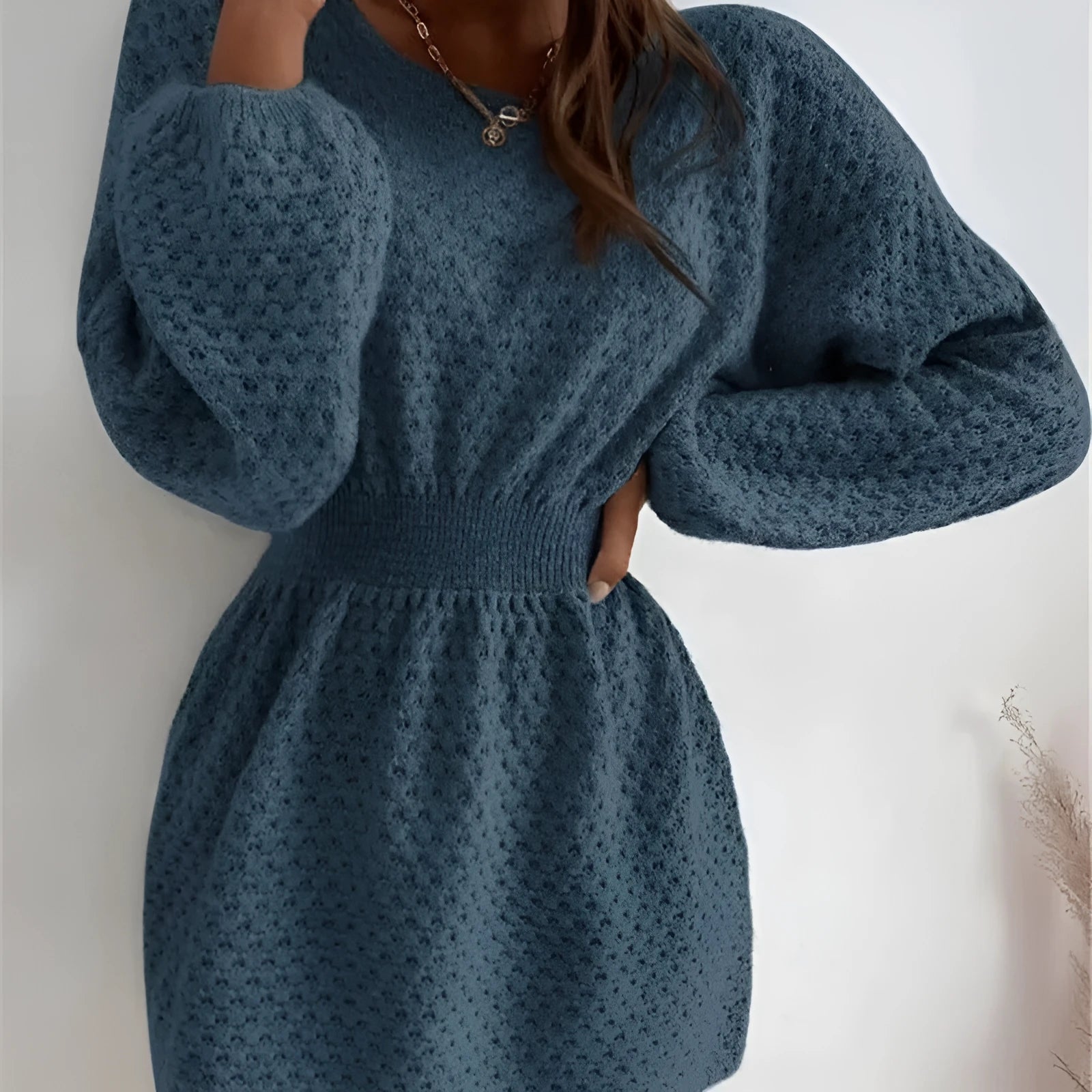 Blue women's knitted dress with hand-crocheted flowers, fitted waist, and 65cm length