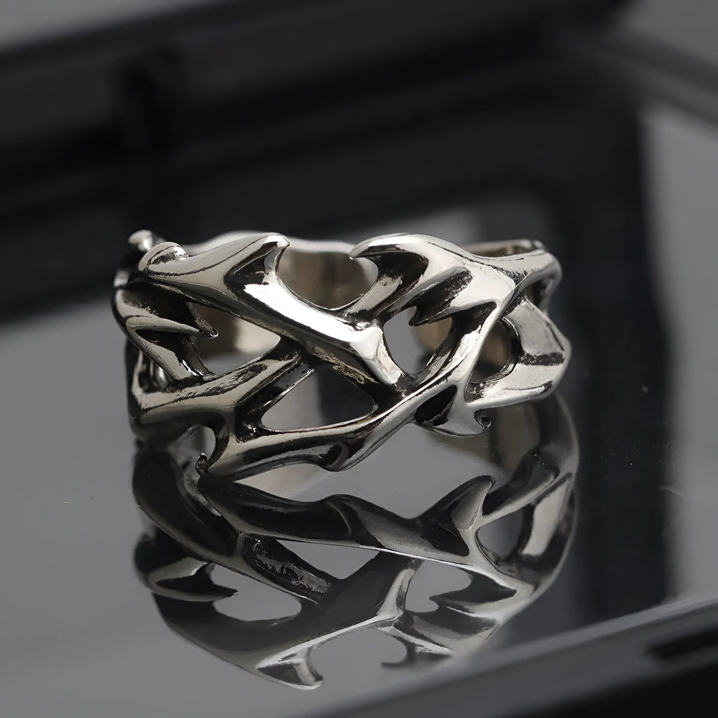 Copper men's ring with geometric thorn and flower design on an adjustable band
