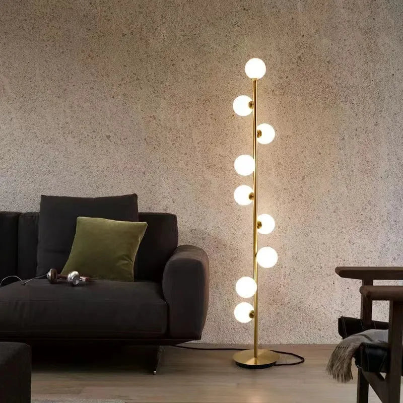 Tall minimalist Nordic floor lamp with wrought iron stem, glass fittings, and a circular white marble base.