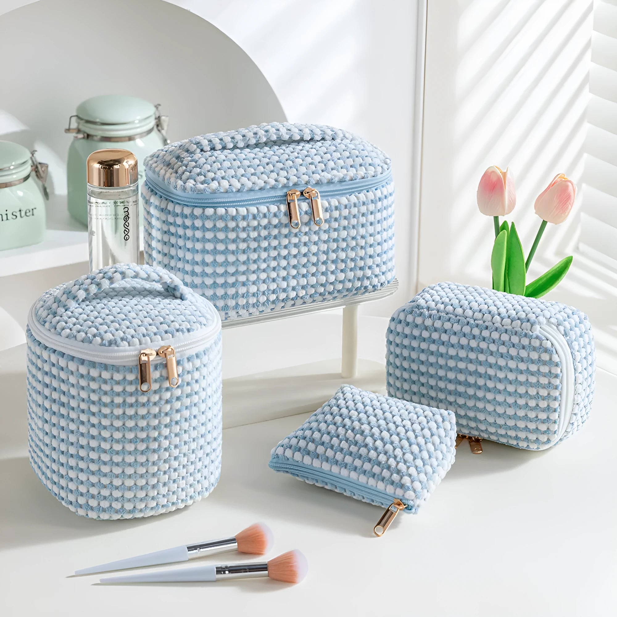 Set of four soft pink flannelette cube makeup bags with zips, arranged from largest to smallest.