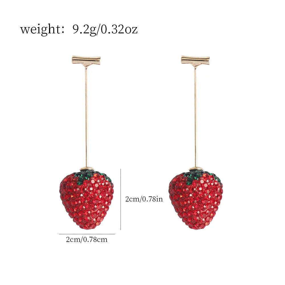 Geometric strawberry shaped zinc alloy earrings with spot drill texture on a red background.