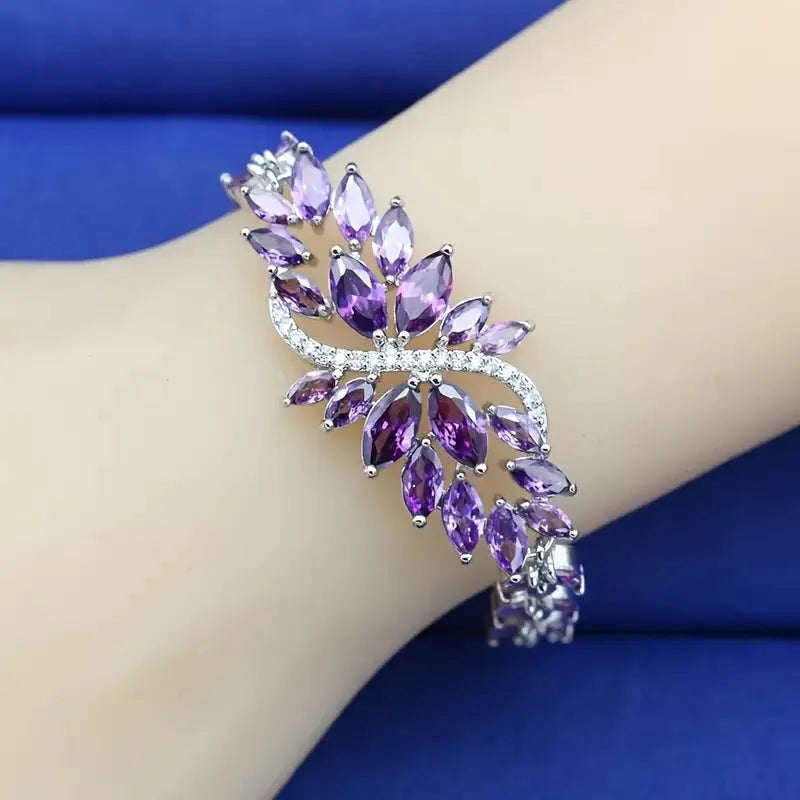 Gold electroplated copper bracelet with coloured zircon stones and ice flower detail.