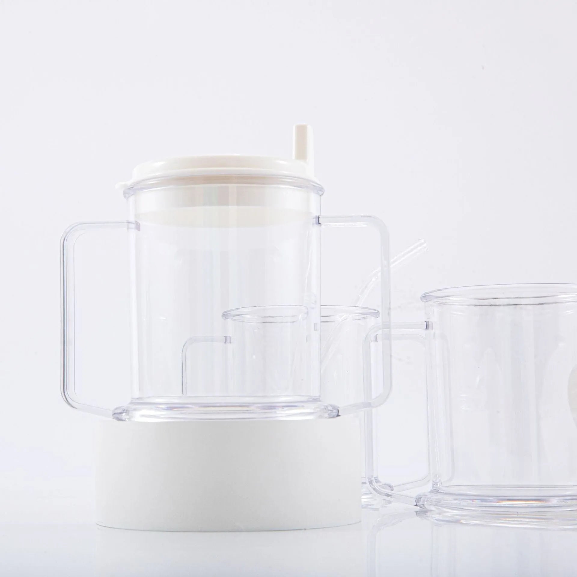 Transparent spill-proof lightweight plastic drinking cup on a table.