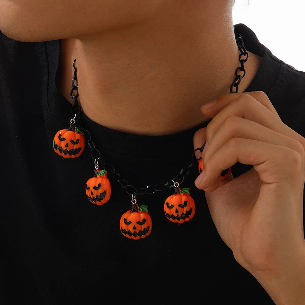 Halloween necklace showing a cartoon ghost and pumpkin acrylic pendant on a chain, colour 06705.