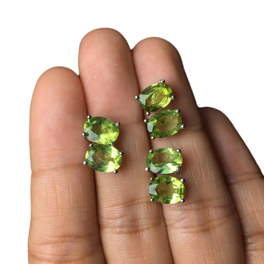 Close-up of grass green natural olivine stud earrings in S925 sterling silver setting.