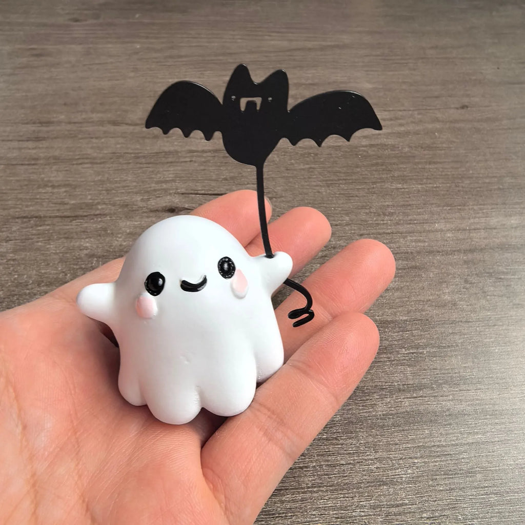 Mini resin Halloween statue of a cartoon ghost walking a bat, 4cm tall