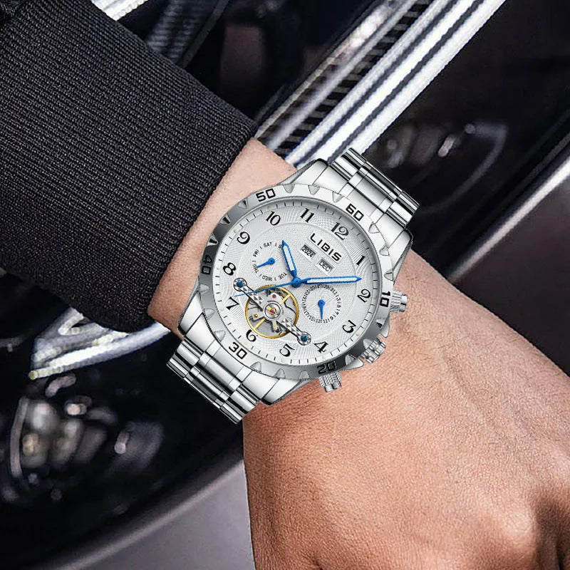 Men's silver automatic perpetual calendar mechanical watch with stainless steel strap on a wrist.