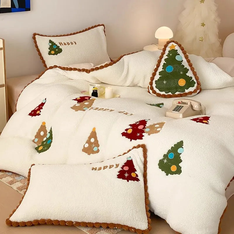 Bright yellow and white Christmas tree fleece bedding set with embroidery on a bed.