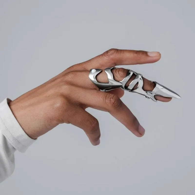 Silver-coloured alloy punk armour finger stall jewellery piece.