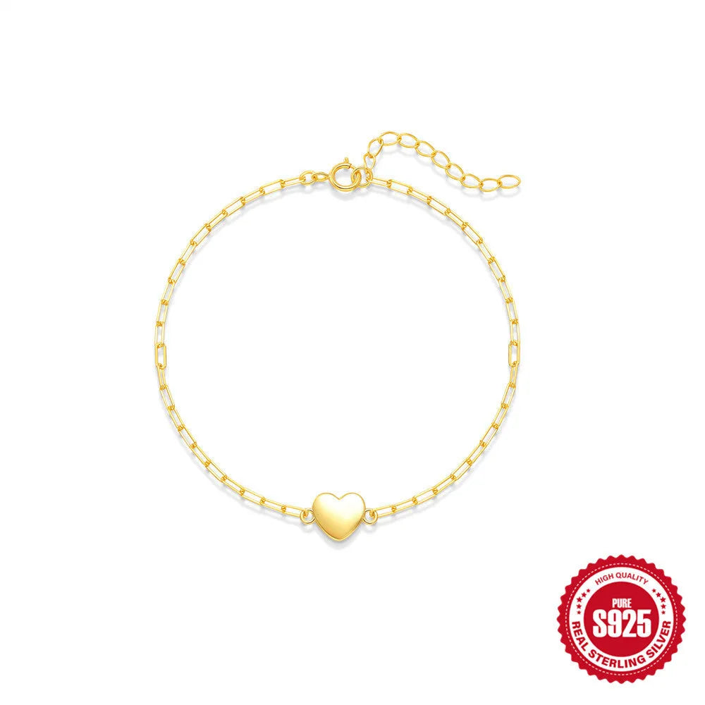 S925 sterling silver women's bracelet with glossy gold tone heart charm and lobster clasp closure