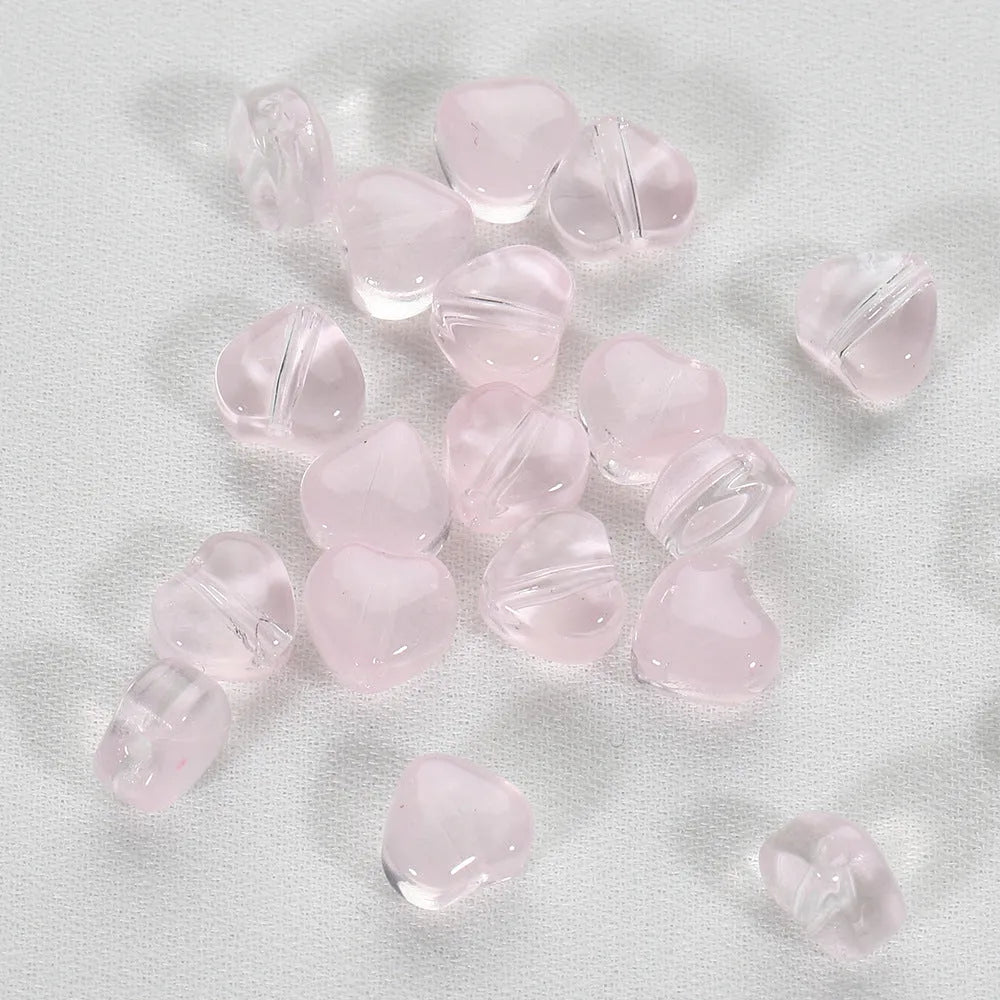 Twenty transparent Czech glass love heart spacer beads in assorted colours including aurora purple and peach gold.