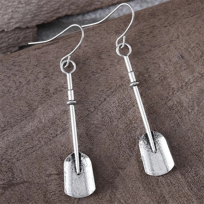 Long antique silver shovel-shaped drop earrings with a geometric retro design.