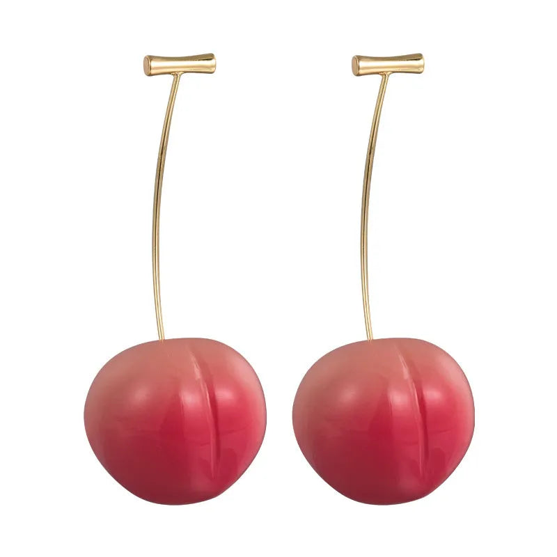 Pair of peach-shaped acrylic fashion earrings with copper posts on a white background.