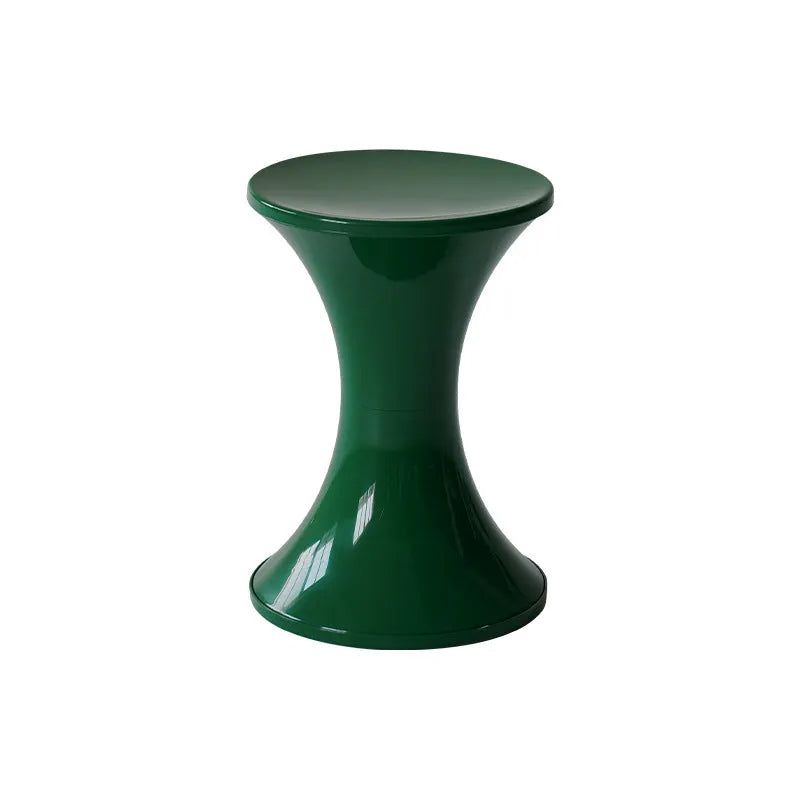 Green plastic hourglass-style shoe changing stool on a wooden floor.