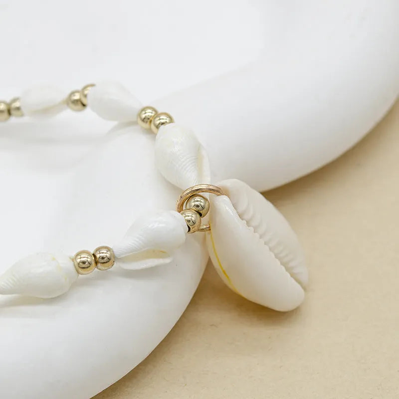 White electroplated conch shell pendant necklace on a regular chain for women.