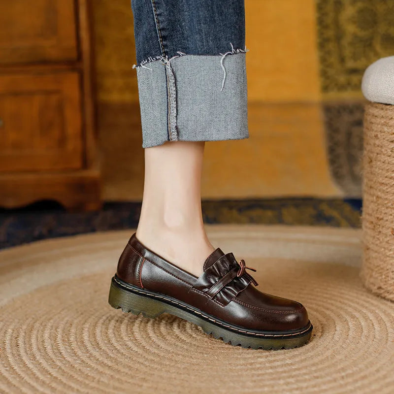 Women's black leather lace-up ankle boots with a round toe and a low chunky heel.