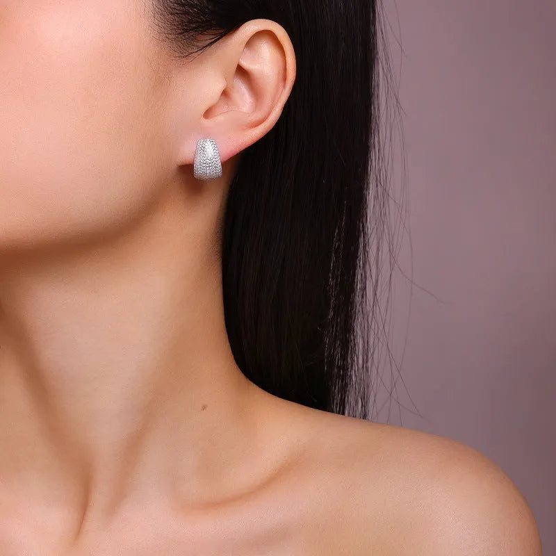 Geometric sterling silver stud earrings with a d-e colour moissanite stone.