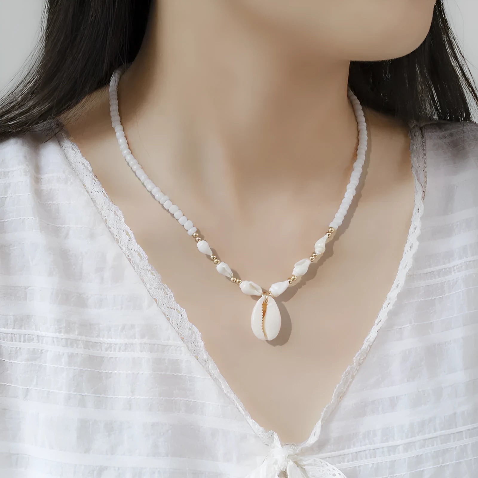 White electroplated conch shell pendant necklace on a regular chain for women.
