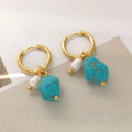 A pair of long and a pair of short geometric copper ear clips with turquoise and cultured pearls.