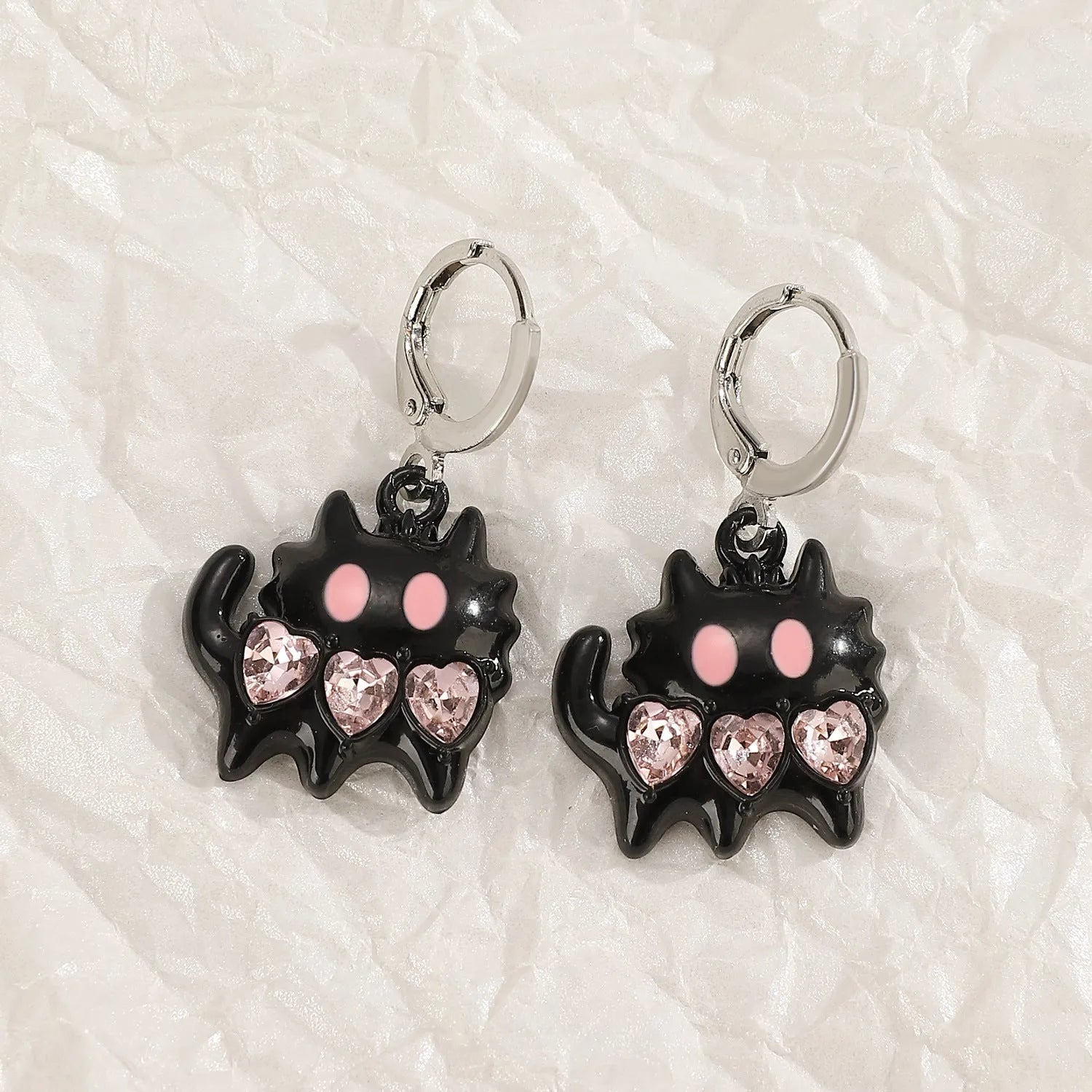 Women's alloy drop earrings showing cross, heart, and animal designs in five colour finishes