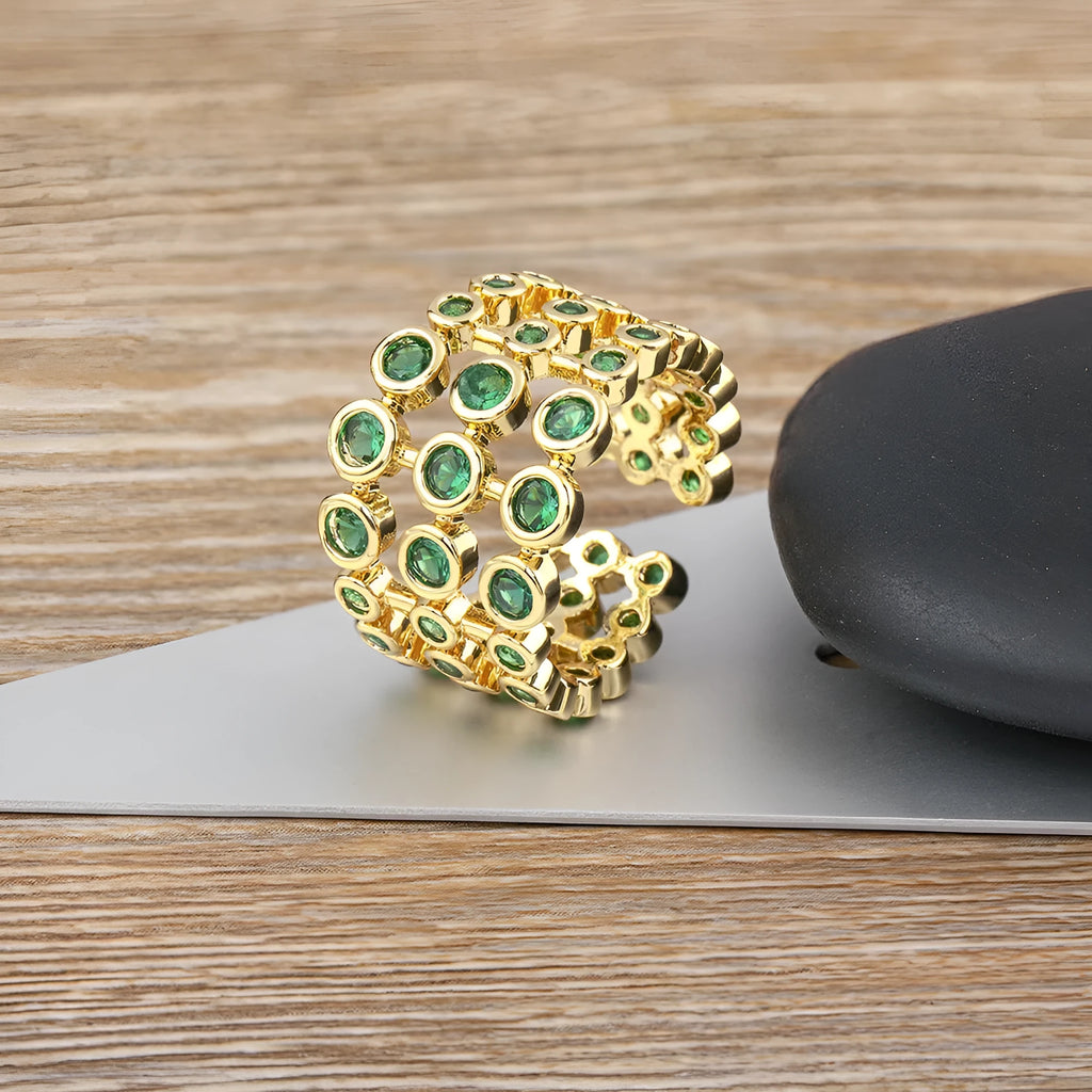 Copper ring with gold plating and green zircon stones on wide band