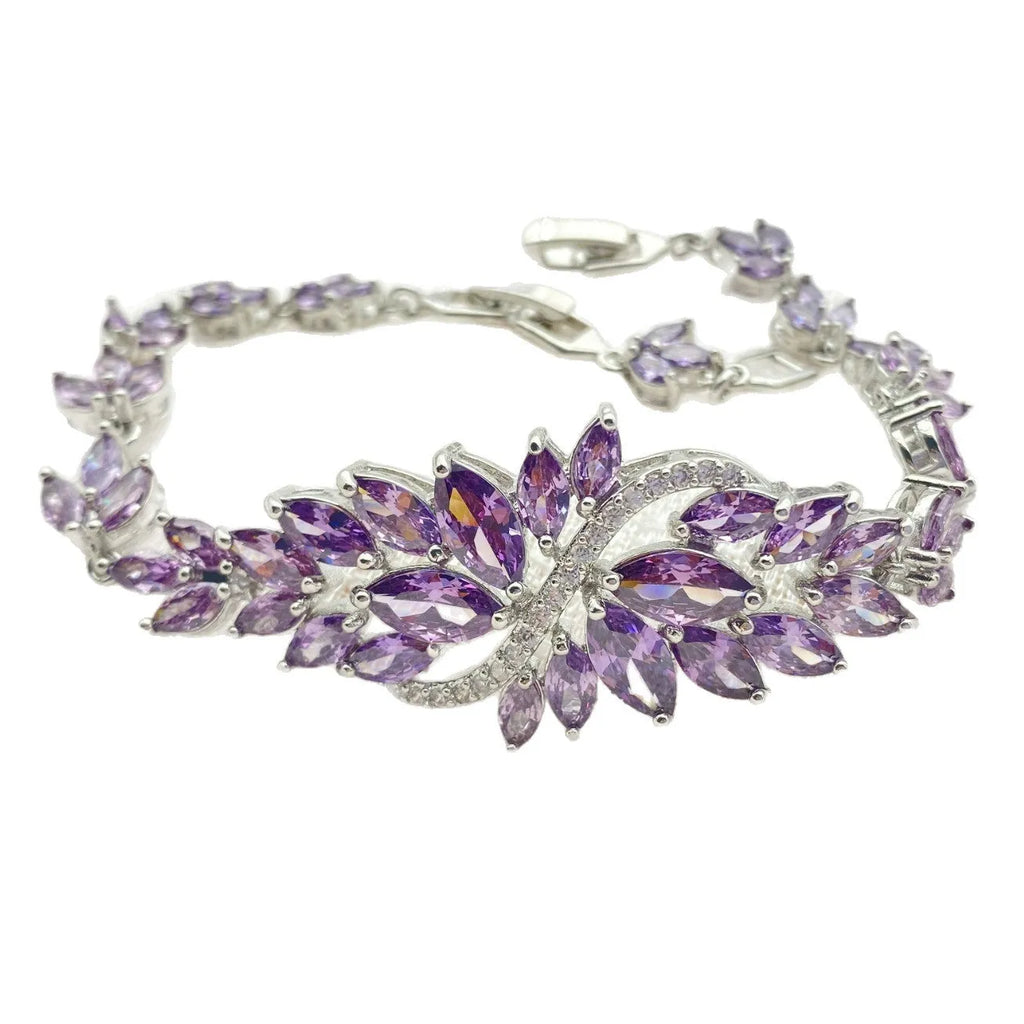 Gold electroplated copper bracelet with coloured zircon stones and ice flower detail.