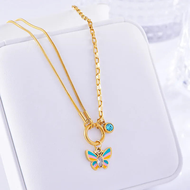 Gold tone epoxy butterfly pendant necklace and bracelet set with snake bone chain.