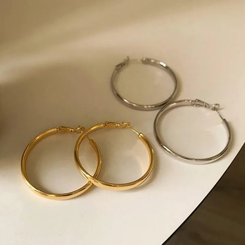 A pair of large gold-coloured metal circle earrings measuring 40mm in diameter