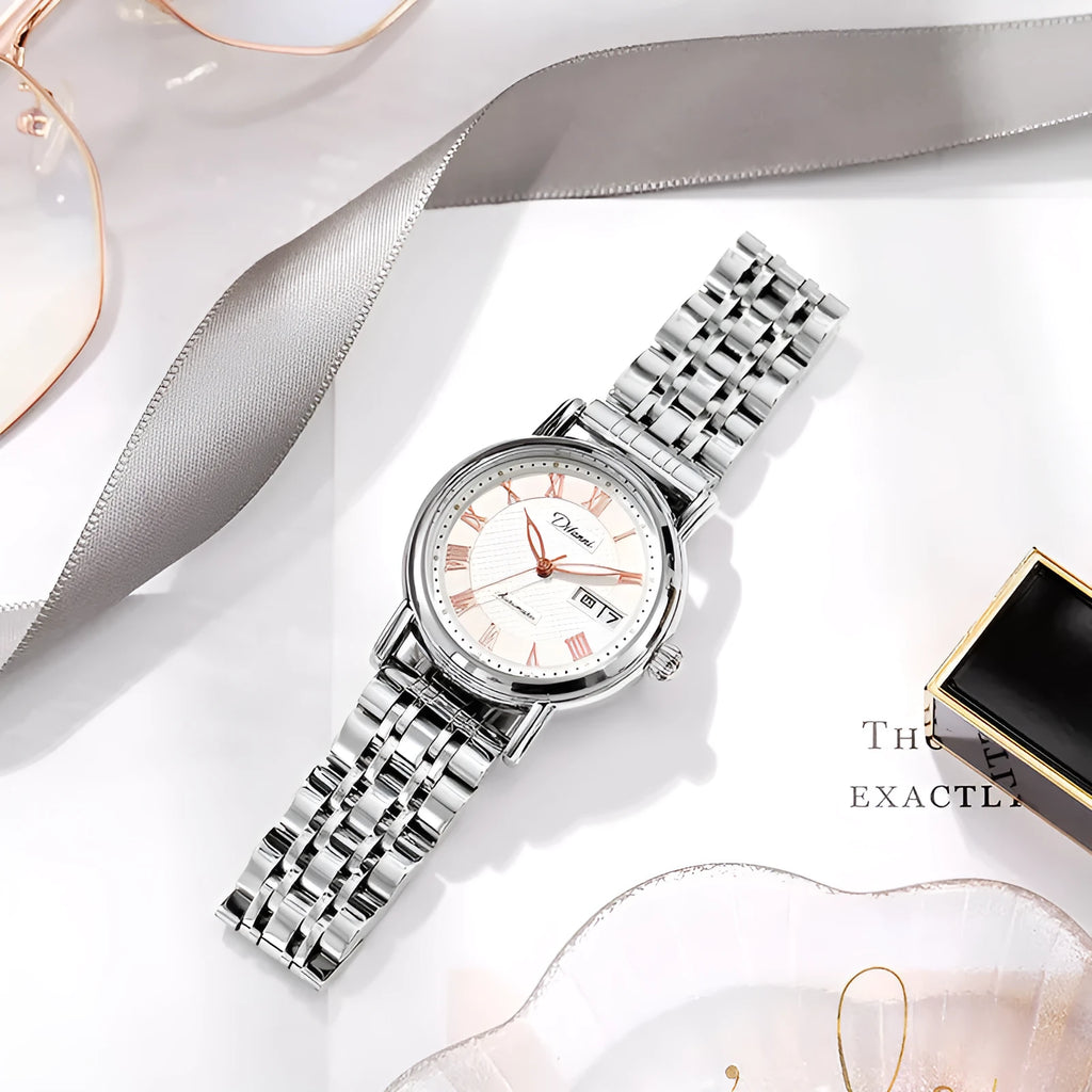 Women's automatic mechanical watch with white dial on a rose gold steel bracelet.