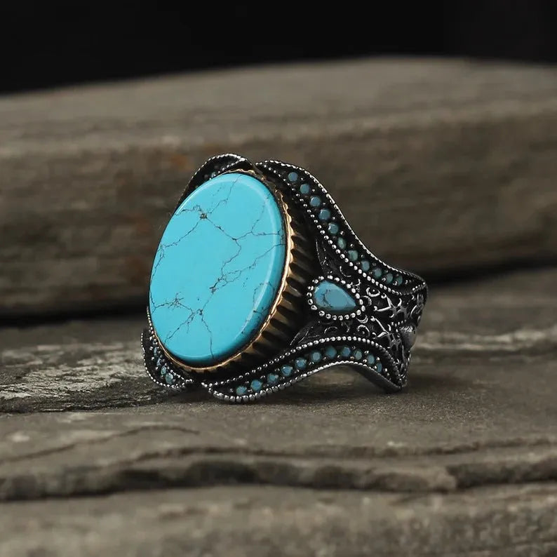 Men's round turquoise ring in antique silver alloy showing simple design and metallic finish