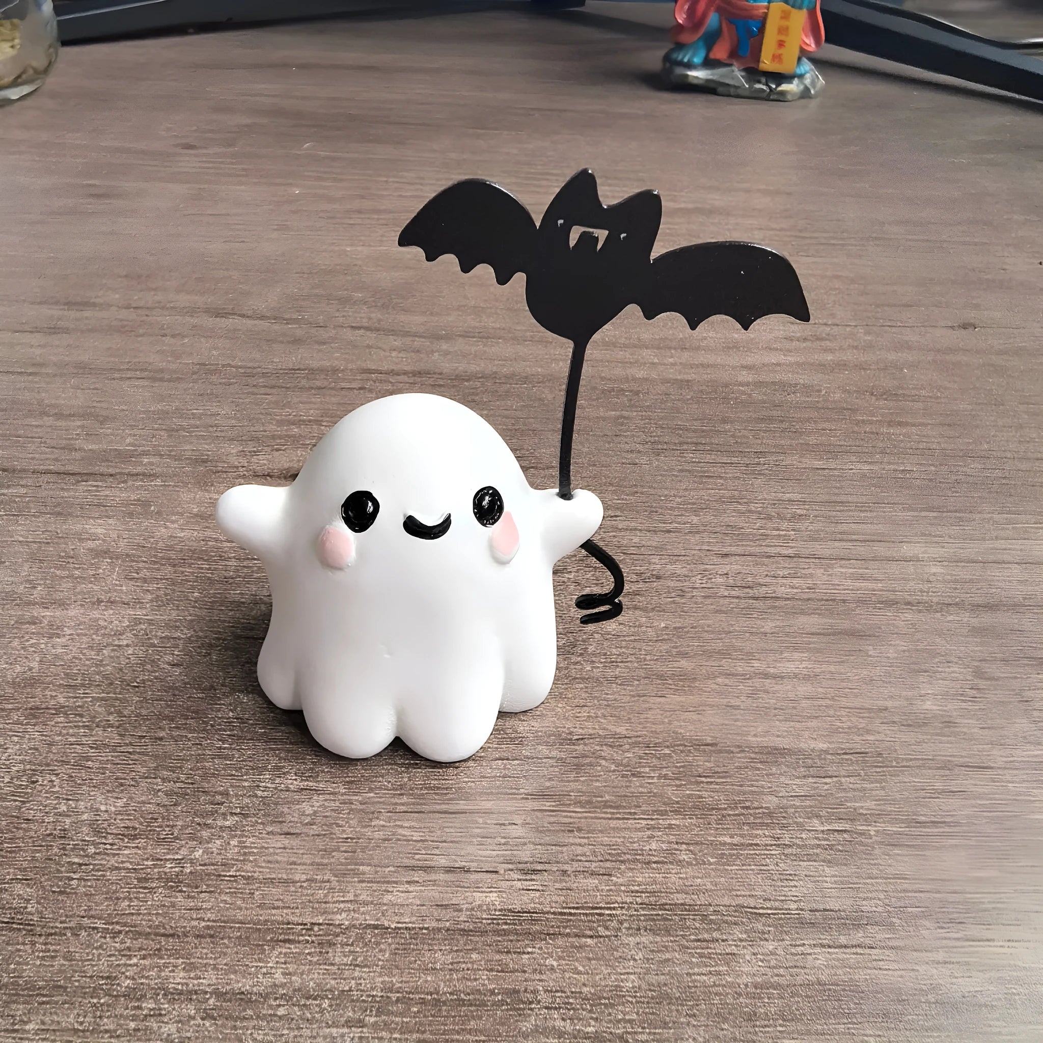 Mini resin Halloween statue of a cartoon ghost walking a bat, 4cm tall