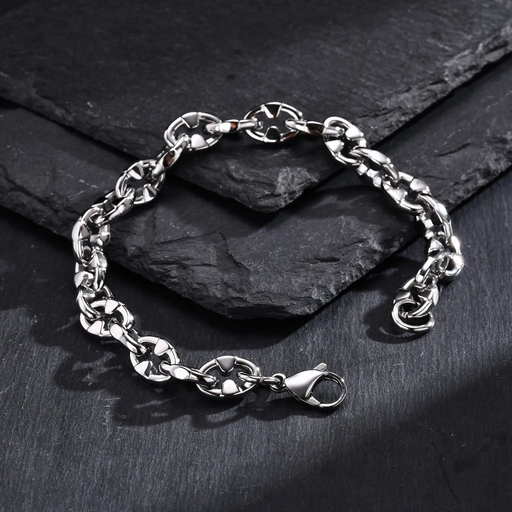 Close-up of a thick stainless steel geometric chain bracelet for men on a wrist.
