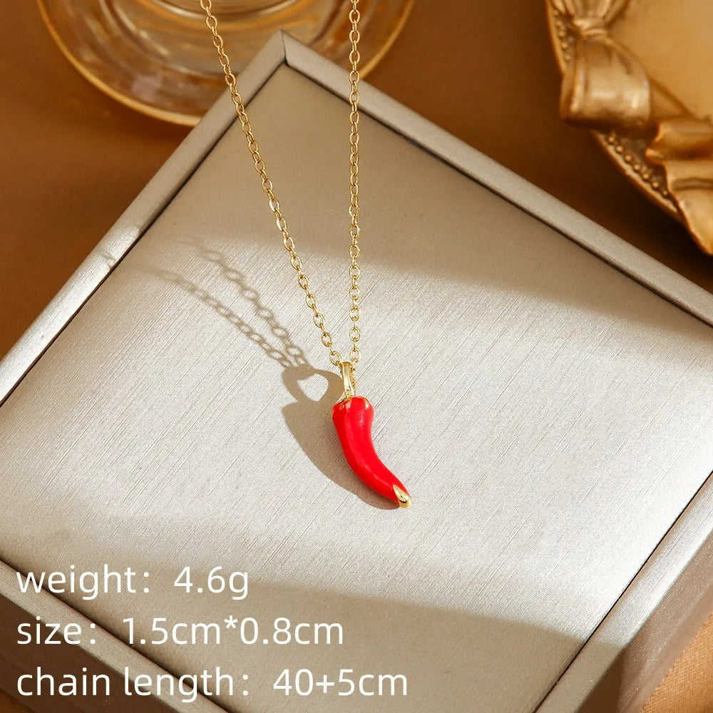Delicate red fruit charm necklace on a titanium steel O-ring chain, showing gold and steel colour options.