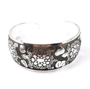 Openwork ethnic bracelet with carved Miao silver finish showing elephant design detail on wrist.