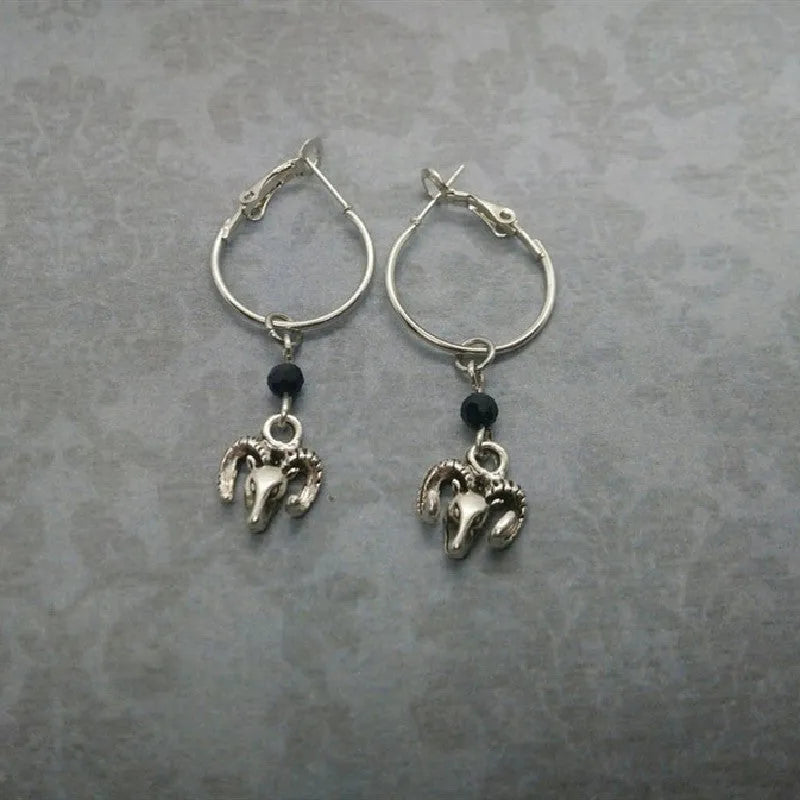 A pair of silver-coloured alloy round ring earrings with a Tibetan antelope design motif.