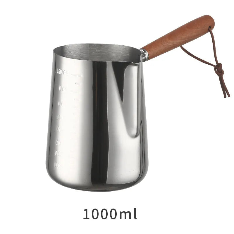 Stainless steel coffee cup with wooden handle and visible millilitre scale markings.