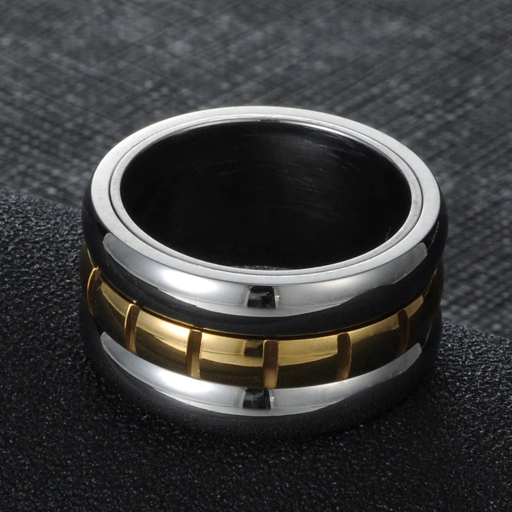 Gold titanium steel ultra-wide knuckle ring with a rotatable tail, shown on a finger.